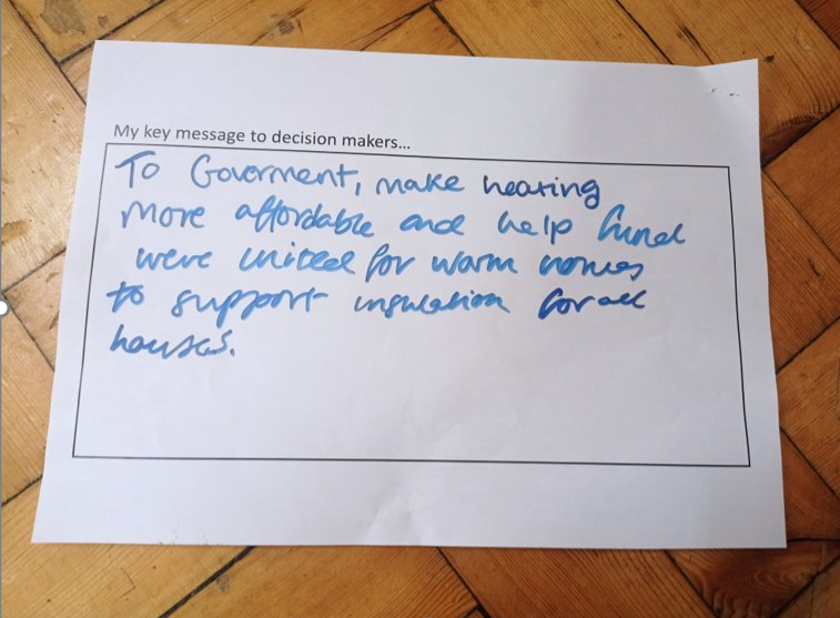 A hand-written message that says: To government, make heating more affordable and help fund United for Warm Homes to support insulation for all houses