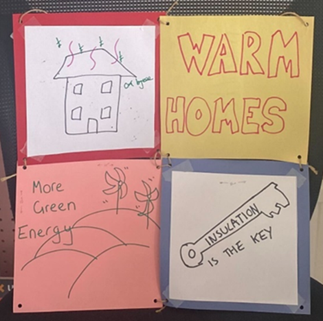 Squares of card attached together with warm homes messages on them