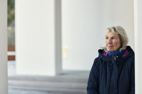 Elderly woman wearing coat outdoors