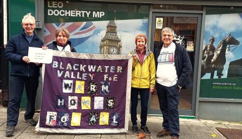 Blackwater Valley Friends of the Earth taking their quilt to their MP's office on the Warm Homes Day of Action