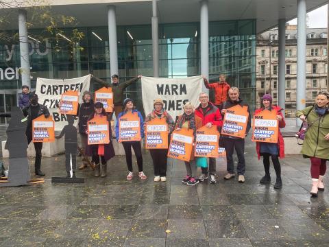 Climate Cymru gather outside the UK Government offices in Cardiff to call for warm homes